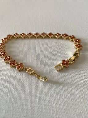 Gold Tone Floral Tennis Bracelet with Orange Crystal Accents